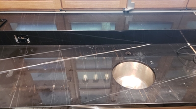 Here is the wet bar sink area before any work was performed. Notice the etching. Photo