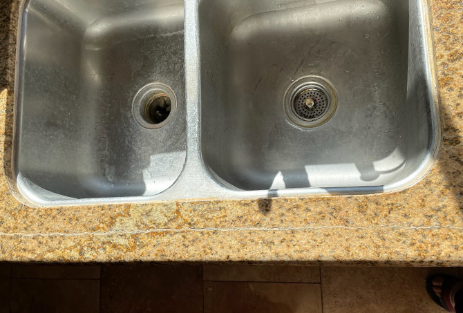 This BEFORE image shows the crack in the granite in front of the sink.