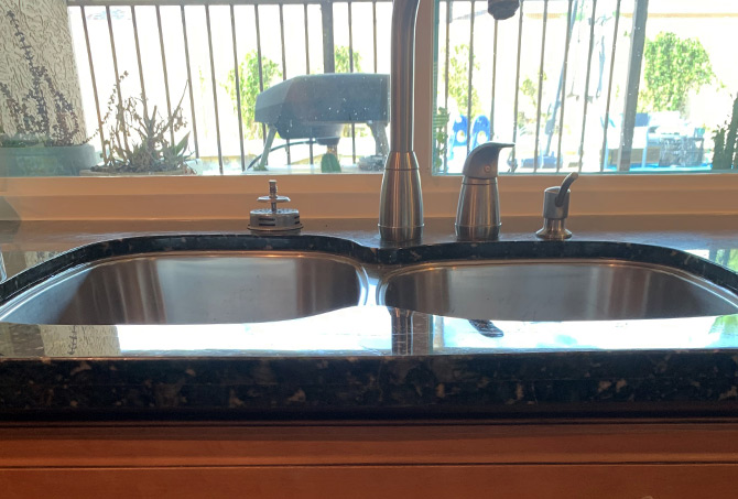Here is the repaired and refinished granite countertop. The light from the window is reflecting off the surface of the granite.