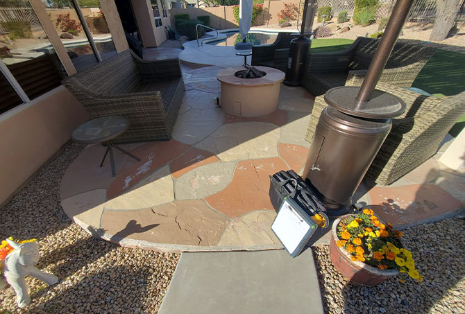 This is a flagstone sitting area with a fire feature that has needs professional attention.