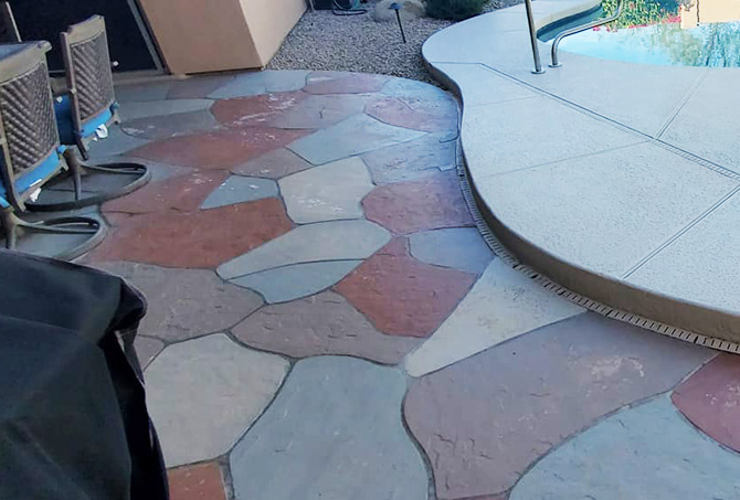 The painted flagstone patio is peeling.