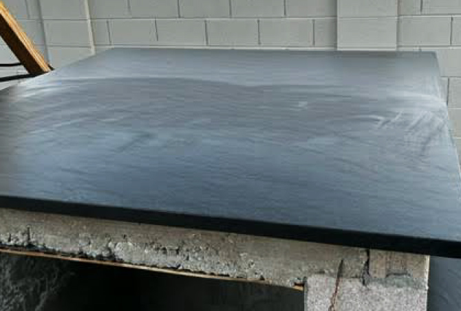 The granite countertop finish is streaked because of improper sealing.