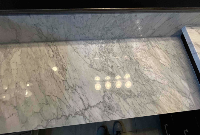 This AFTER image shows the beautiful reflection of the overhead lights in the marble.