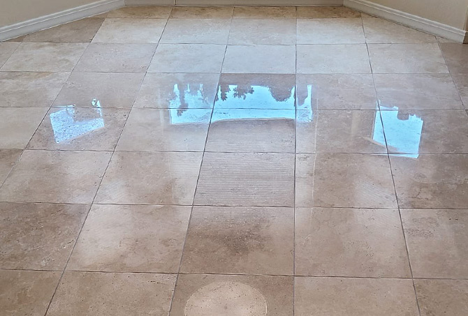 Light from the windows reflects clearly on the newly restored travertine floor.