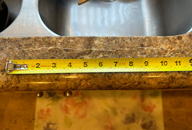 Here is the crack in granite countertop along the edge of the sink.