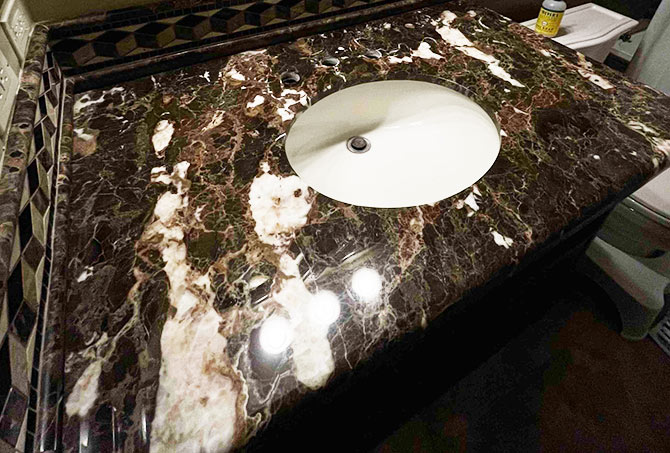 This image shows the restored and sealed marble vanity.