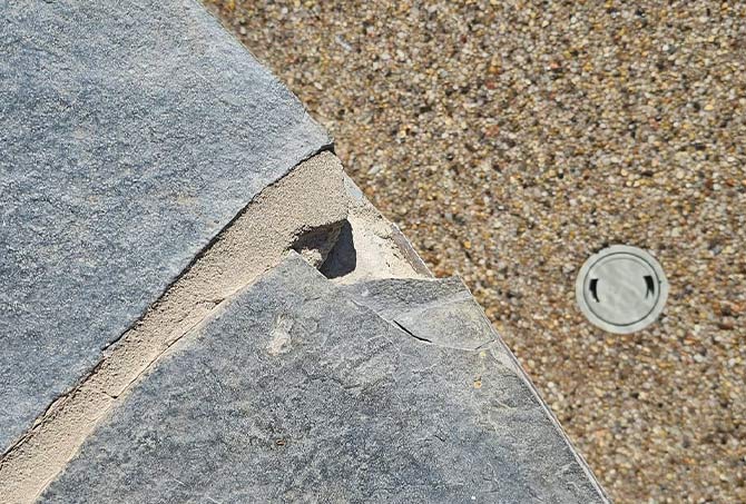 The flagstone was chipped and damaged in certain placed.