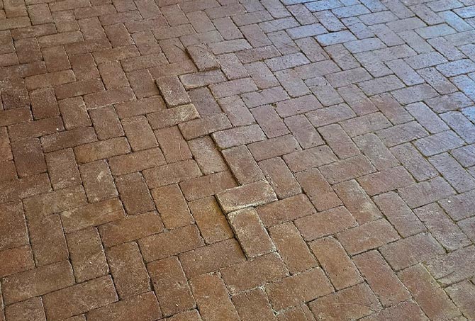This image shows where the brick pavers had settled, creating an uneven surface.