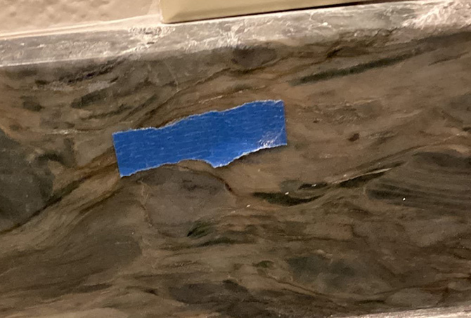 Here is a scratch on the backsplash part of the granite vanity top.